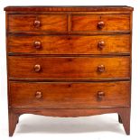 A 19TH CENTURY MAHOGANY BOW FRONTED CHEST OF TWO SHORT AND THREE LONG DRAWERS with turned knob