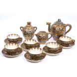 A JAPANESE IMARI PATTERN TEA SET with figural decoration, serpent handles and character mark to