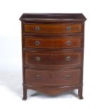 A SMALL GEORGIAN STYLE BOW FRONTED CHEST OF FOUR DRAWERS standing on bracket feet, 61cm wide x 44.