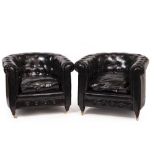 A PAIR OF BLACK LEATHERETTE TUB CHAIRS with buttoned backs, on brass casters, 86cm x 70cm x 70cm (2)