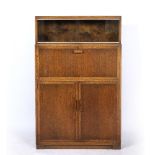 A MINTY OAK BUREAU CABINET with glazed sliding doors to the upper section above a fall front with