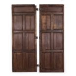 A PAIR OF OAK PANELLED DOORS with butterfly hinges, each door 70cm wide x 190.5cm high Condition:
