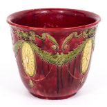 AN ART NOUVEAU STYLE POTTERY JARDINIERE with red and green glaze, 37cm wide x 30cm high Condition: