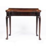 A GEORGE II MAHOGANY CARD TABLE with a folding top with rounded corners opening to reveal a green