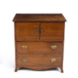 A SMALL MAHOGANY LOW CABINET with twin cupboard doors over two drawers and on splaying bracket feet,