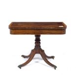 AN EARLY 19TH CENTURY MAHOGANY FOLD OVER CARD TABLE with rosewood crossbanded top, turned column