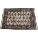 AN ORIENTAL BLUE AND YELLOW GROUND RUG with geometric decoration, 158cm x 223cm together with a