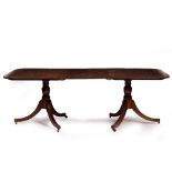 A GEORGIAN STYLE MAHOGANY TWIN PEDESTAL DINING TABLE with extra leaf, 213cm long x 106cm wide x 73.