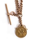 A GEORGE V GOLD SOVEREIGN dated 1915 with a mount attached to a 9 carat gold watch chain