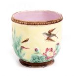A 19TH CENTURY MAJOLICA JARDINIERE decorated with pond lilies, swifts and a bull rush design on a