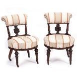 A PAIR OF 19TH CENTURY WALNUT OCCASIONAL CHAIRS with overstuffed upholstered back and seat, urn