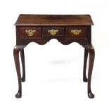 A GEORGIAN MAHOGANY THREE DRAWER SIDE TABLE with brass swan neck handles, and cabriole legs, 72cm