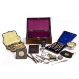 AN OLD BOX CONTAINING A SILVER MOUNTED PHOTOGRAPH FRAME a cased part dressing table set, further