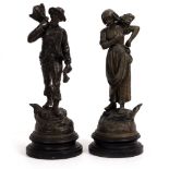 A PAIR OF SPELTER AGRICULTURAL FIGURES on turned ebonised bases, each 37cm high Condition: surface