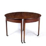 AN EDWARDIAN MAHOGANY D END DINING TABLE with a central drop leaf section, square tapering