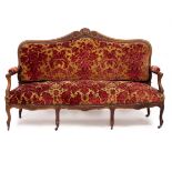 AN OLD 18TH CENTURY FRENCH STYLE WALNUT SOFA with shell carved cresting rail, open arms and standing