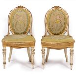 A PAIR OF 19TH CENTURY FRENCH CREAM AND GILT PAINTED SIDE CHAIRS with embroidered seats, 48cm wide x