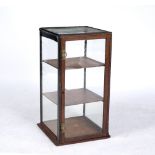 A SMALL SQUARE SECTION TABLE TOP DISPLAY CABINET with glazed top and sides, hinged door to one