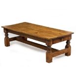 A RECTANGULAR LOW PINE COFFEE TABLE with a single drawer to either end, the legs united by an H