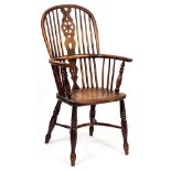 AN EARLY 19TH CENTURY WINDSOR CHAIR with yew wood supports, elm seat and crinoline stretcher, 56cm