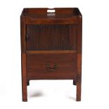 A 19TH CENTURY MAHOGANY TAMBOUR FRONTED COMMODE CABINET with pierced carrying handles to the