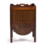 A 19TH CENTURY MAHOGANY TAMBOUR FRONTED COMMODE with pierced handles to the galleried top with