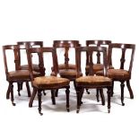 A SET OF NINE VICTORIAN MAHOGANY BAR BACK DINING CHAIRS with brown leatherette upholstered seats and