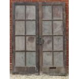 A LARGE PAIR OF HEAVY OAK FRAMED DOORS each with eight glazed panels, each 86cm wide x 237cm high