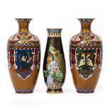 A PAIR OF ORIENTAL CLOISONNE DECORATED VASES decorated with butterflies and exotic birds, 29.5cm