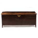 AN OAK SIX PLANK CHEST OR COFFER with wrought iron hinges, 129cm wide x 44.5cm deep x 52.5cm high