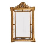 AN ANTIQUE POSSIBLY CONTINENTAL PIER GLASS with gesso moulded gold painted frame, central bevelled