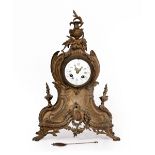 A LATE 19TH CENTURY FRENCH GILT METAL MANTLE CLOCK with an urn finial and scrolling acanthus leaf