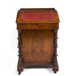 A VICTORIAN WALNUT DAVENPORT DESK with hinged galleried lid to the top enclosing compartments