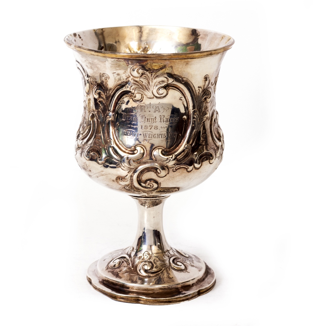 A LARGE GEORGIAN SILVER CUP with embossed / engraved floral cartouches and engraved with 'R A Drag