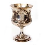A LARGE GEORGIAN SILVER CUP with embossed / engraved floral cartouches and engraved with 'R A Drag