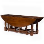 AN OAK WAKE TABLE with turned supports, 222cm long x 76cm high Condition: minor surface marks,