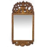 AN 18TH CENTURY STYLE VENETIAN GILT WALL MIRROR the crest decorated with a case of flowers with