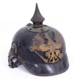 A WORLD WAR I IMPERIAL GERMAN PICKELHAUBE with a black leather shell, a metal helmet plate, a
