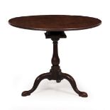 A GEORGE III MAHOGANY CIRCULAR TILT TOP TRIPOD TABLE with bird case support, baluster column and