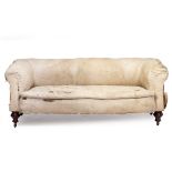 A LATE VICTORIAN SOFA with turned walnut legs and brass and ceramic casters, in the manner of