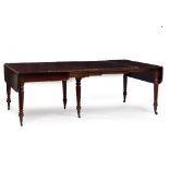 AN ANTIQUE MAHOGANY EXTENDING DROP LEAF DINING TABLE in the manner of Gillows with reeded tapering