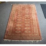 A PERSIAN STYLE RED GROUND RUG with geometric decoration, 94cm x 159cm Condition: tassels worn,
