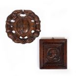 AN OLD WALNUT CARVED PANEL depicting a bust of a man wearing a military helmet, possibly