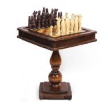 A MODERN GAMES TABLE with inset chess board top and single frieze drawer, all on a turned column