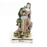 AN ANTIQUE STAFFORDSHIRE POTTERY FIGURINE 'Widow' circa 1800, 13cm wide x 24.5cm high Condition: