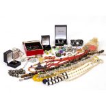 A MIXED COLLECTION OF COSTUME JEWELLERY to include bead necklaces and brooches At present, there
