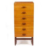 A TEAK G PLAN NARROW CHEST OF SIX DRAWERS on a shaped stand, marked with a stamp to the bottom