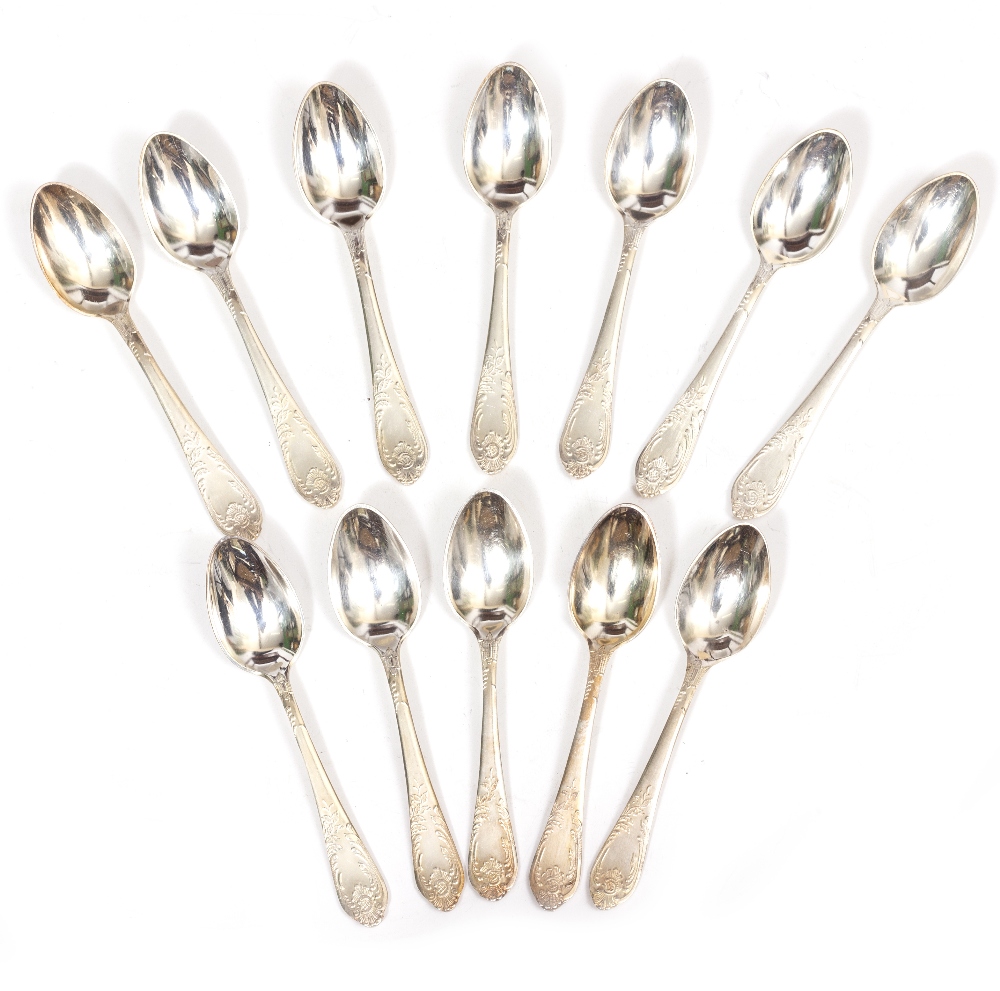 AN EXTENSIVE CANTEEN OF SILVER PLATED CUTLERY decorated to the finial and handles with scrolling