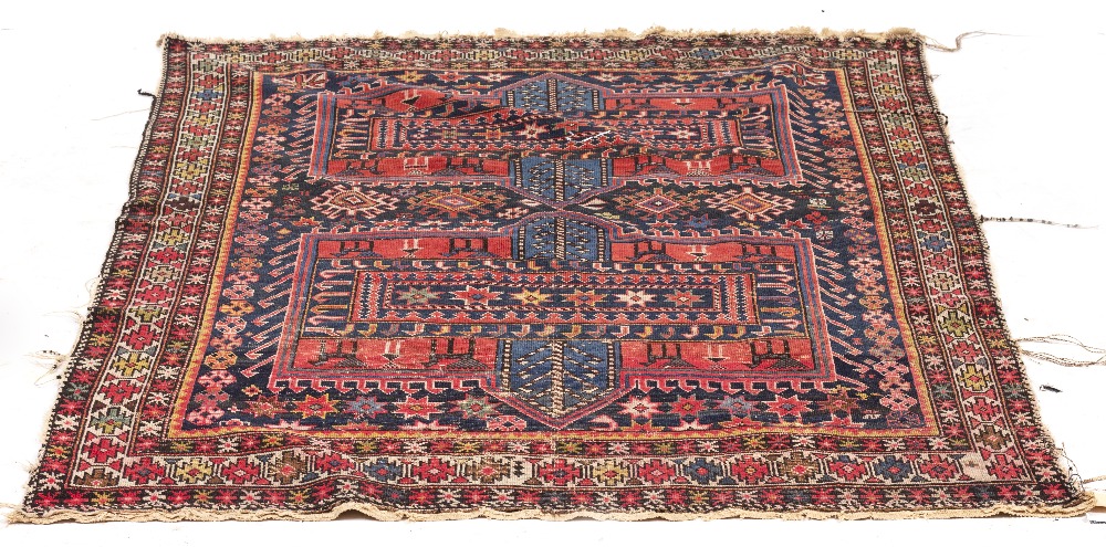 A PERSIAN POLYCHROME RUG with geometric decoration, 113cm x 115cm Condition: extensive wear and