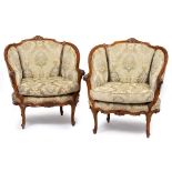 A PAIR OF FRENCH STYLE WALNUT ARMCHAIRS with overstuffed upholstered backs and seats with squab